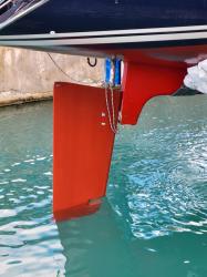 The result: Note the hanging rudder and the missing bottom half of the skeg that supports it. Oops.